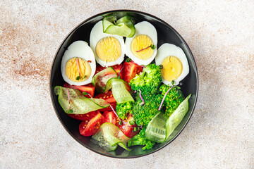 salad buddha bowl boiled egg, broccoli, tomato, cucumber, vegetables meal snack on the table copy space food background veggie vegan or vegetarian 