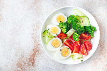 salad buddha bowl boiled egg, broccoli, tomato, cucumber, vegetables meal snack on the table copy space food background veggie vegan or vegetarian 