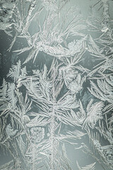 Flowery ice patterns forming on glass
