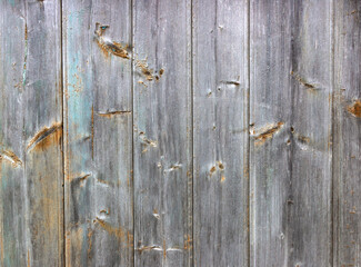 Old grey and blue wooden background with cracks and scratches in vintage style