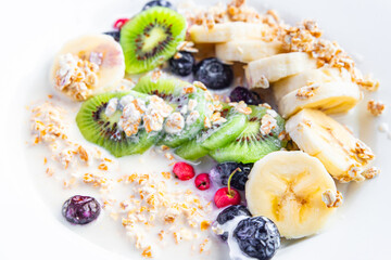 oatmeal breakfast bowl fruit vegetable milk, gluten free, lactose free, banana, kiwi, berrie, blueberrie meal snack on the table copy space food background rustic 