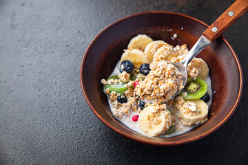 oatmeal breakfast bowl fruit vegetable milk, gluten free, lactose free, banana, kiwi, berrie, blueberrie meal snack on the table copy space food background rustic 