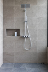 Shower at bathroom. ฺBathroom interior with shower stall and soap Gel bottle. Luxury fully tiled...