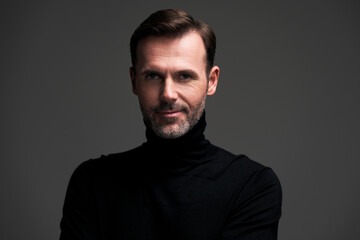 Portrait of handsome man in dark wall