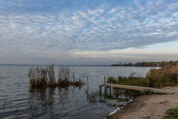 Colorful sunrise on the shores of Lake Nero. Autumn landscape with a lake in the early morning. A...