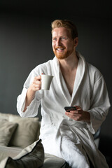 Handsome man having cup of coffee at home in the morning