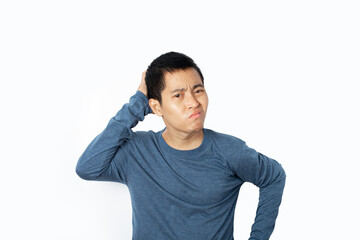 Portrait of young man wearing t-shirt feeling disappointed isolated on white background.