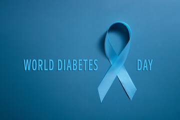 Blue ribbon on blue background symbol of world diabetes day 14 november copy space