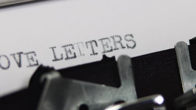An old fashioned vintage typewriter spelling out the word Love Letters, old fashioned love letter or romance story concept