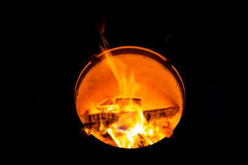 The fire burns in a narrow circle of the stove. Fiery circle