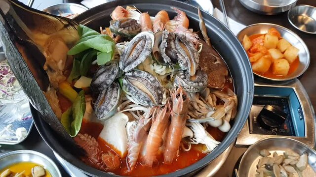 Cooking with fresh seafood in seafood soup