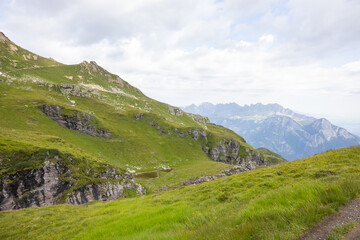 Amazing hiking day in one of the most beautiful area in Switzerland called Pizol in the canton of Saint Gallen. What a wonderful landscape in Switzerland at a sunny day. Beautiful alpine lake.