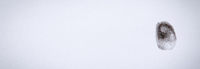 Black print of finger on paper.