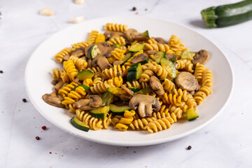 Fusilli pasta with mushrooms and zucchini.