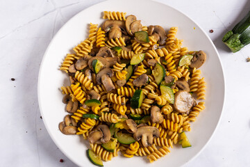 Fusilli pasta with mushrooms and zucchini.