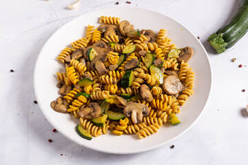 Fusilli pasta with mushrooms and zucchini.