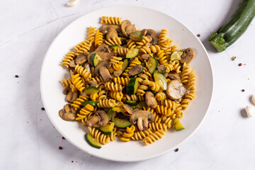 Fusilli pasta with mushrooms and zucchini.