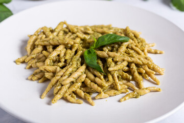 Trofie with pesto, Italian pasta with basil sauce. Pasta with pesto on a white background