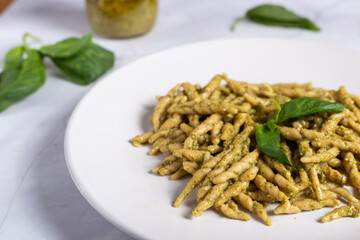 Trofie with pesto, Italian pasta with basil sauce. Pasta with pesto on a white background