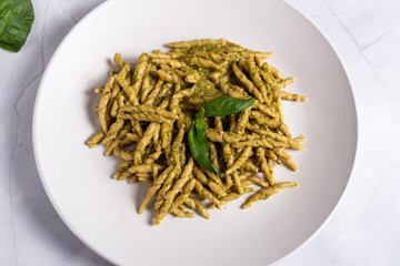 Trofie with pesto, Italian pasta with basil sauce. Pasta with pesto on a white background