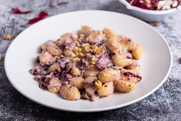 Vegan potato gnocchi with walnut and radicchio sauce