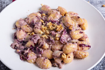 Vegan potato gnocchi with walnut and radicchio sauce