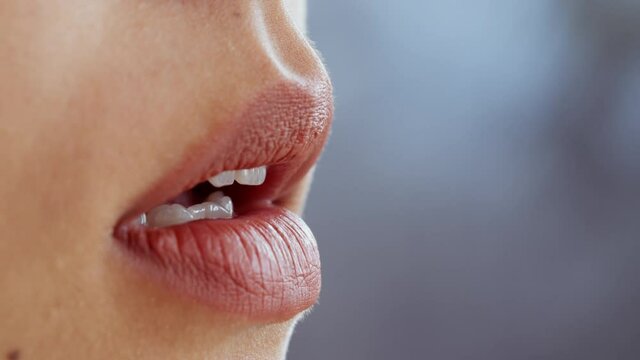 Lips moisturizing. Close up shot of moisturized female lips, unrecognizable woman applying nourishing balm, empty space