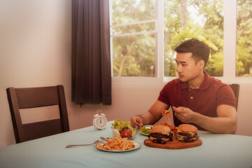 Concepts, problems, and disunity in the family : One young man sat for lunch alone, watching the empty chair without his wife who had eaten together because of family problems - obrazy, fototapety, plakaty