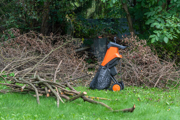 Electric garden shredder of branches and leaves - Powered by Adobe