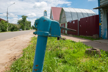Water supply hydrant in the vintage old in retro style of the times of the USSR against the...