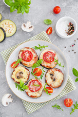 Eggplant pizza with tomatoes sauce, mozzarella, mushrooms and fresh basil. Vegetarian dish. Selective focus