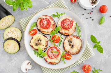 Eggplant pizza with tomatoes sauce, mozzarella, mushrooms and fresh basil. Vegetarian dish. Selective focus