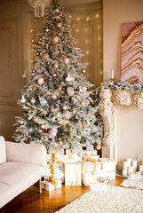 Elegant decorated Christmas tree with boxes of gifts in the interior near the sofa