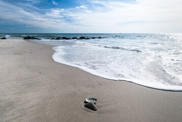Deserted Long Island beach at fall, seashell, sand, waves, foam