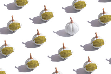 Pattern pumpkin in a medical mask with glitter. Creative Thanksgiving and halloween during coronavirus pandemic