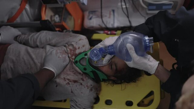 Team of ems paramedics rescuing child in ambulance