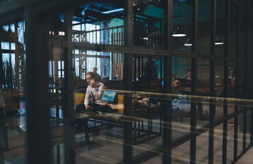 Obraz na płótnie Canvas People working in spacious modern workspace in daytime