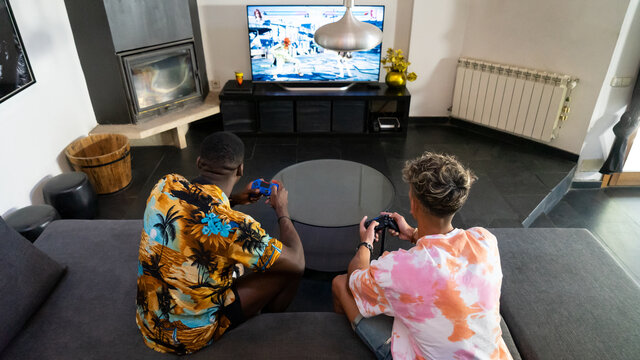 Unrecognizable diverse friends playing videogame