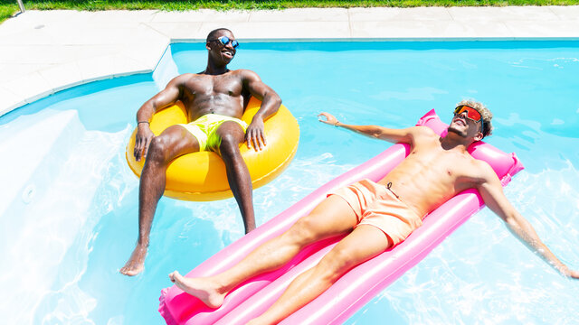Diverse friends relaxing in swimming pool