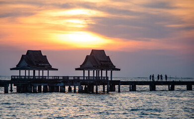 During the sunset, look through the abandoned pavilion in the middle of the sea at Chittaphawan Temple, Chonburi Province, Thailand.