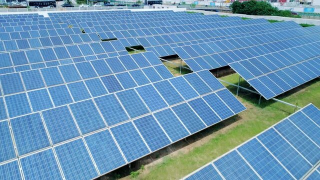 Aerial view of Solar Panels Farm solar cell. Renewable green alternative energy concept. Camera moves backwards