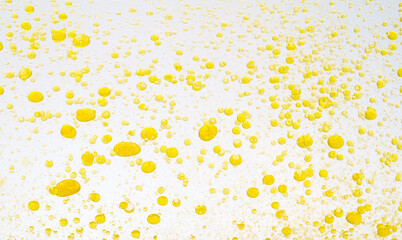Oil drops isolated. Golden liquid drops of oil in water on a white background. Food or cosmetics...
