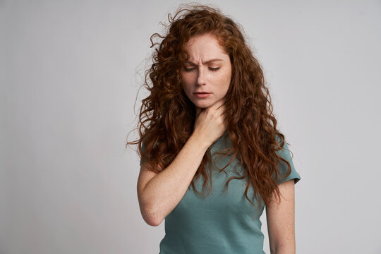 Young woman with serious sore throat