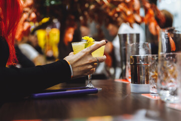 Yellow cocktail on the bar.