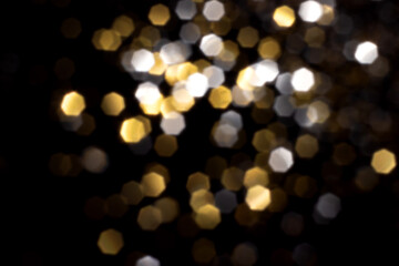 Golden and silver blurred bokeh lights on black background. Glitter sparkle stars for celebrate. Overlay for your design