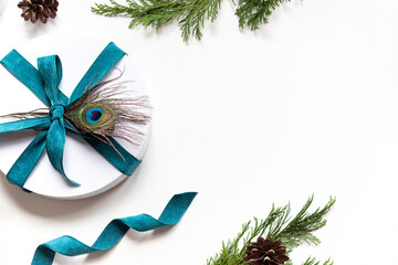 Christmas round white gift box with peacock feather frame. Winter holiday festive greeting card....