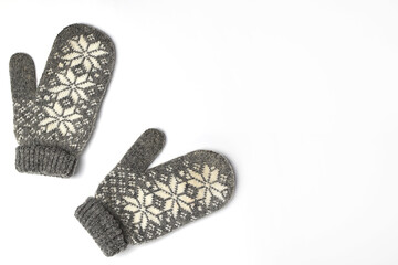 Winter woolen mittens with a pattern isolated on a white background. Winter accessory. Flat lay, top view.