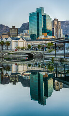 Portrait shot of Cape Town city on canal with buildings reflection in the water during sunset