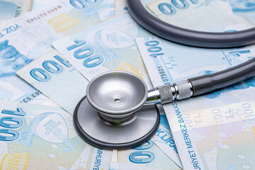 Turkish Currency and Stethoscope. Turkish Lira TL. Turkish banknotes. 100 Turkish Lira. Devaluation...