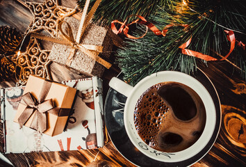 Cup of coffee, christmas toys on a wooden background
